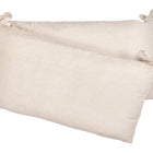 Zwei beige-taupefarbene Bettumrandung Nestchen Cord Breitcord Kissen von KraftKids, hergestellt aus 100% Baumwolle mit gerippter Struktur und dekorativen Stoffbändern, überlappen sich auf einem einfarbig weißen Hintergrund.